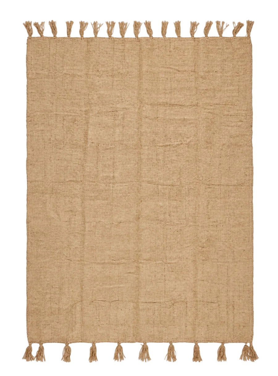 A natural sand beige jute kilim with fringed edges