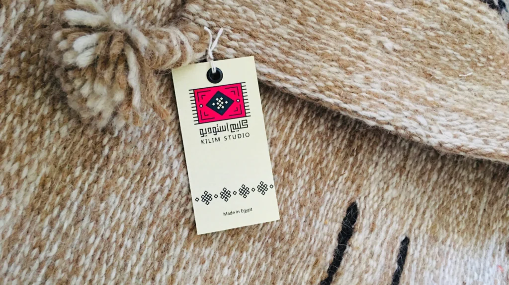 A Kilim Studio label attached to the natural fibers of a handwoven Egyptian rug